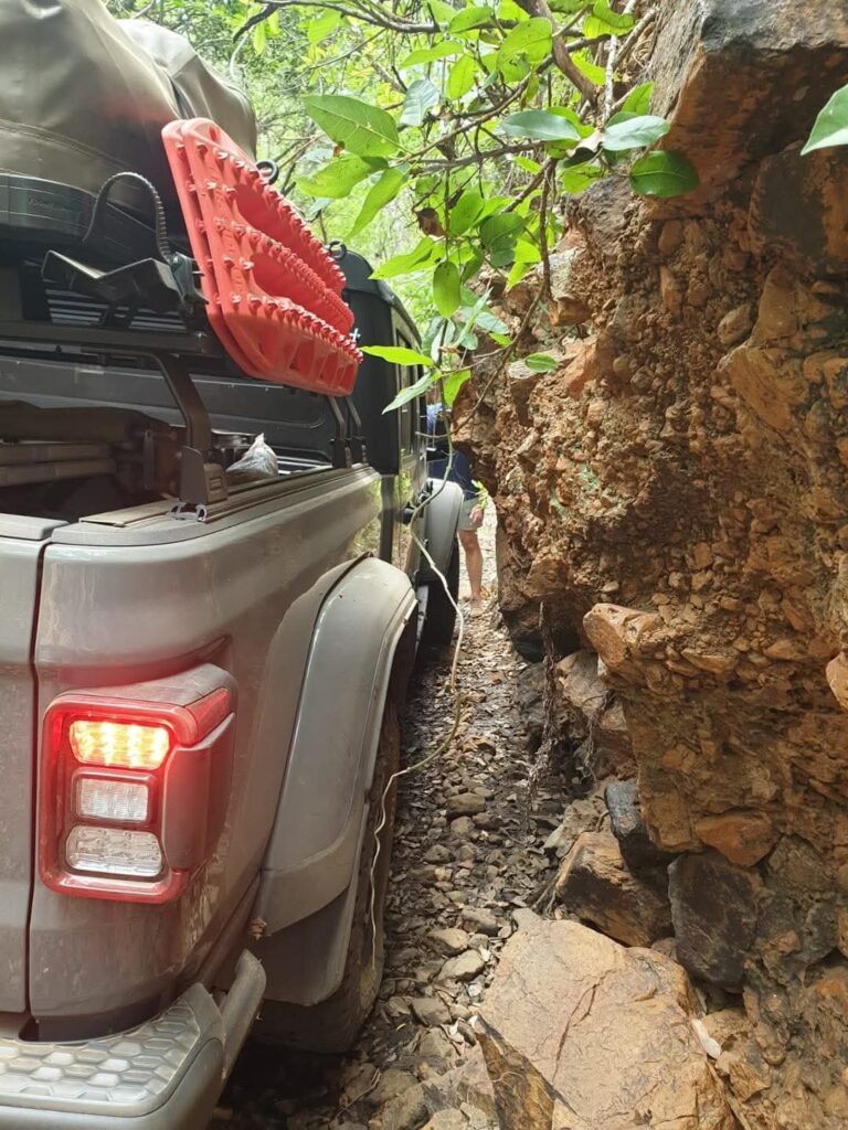 A vehicle negotiating the narrow rock passage