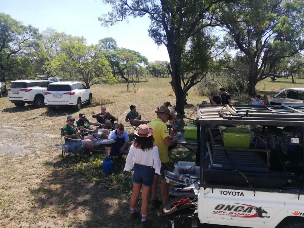 The convoy taking a break beneath the trees